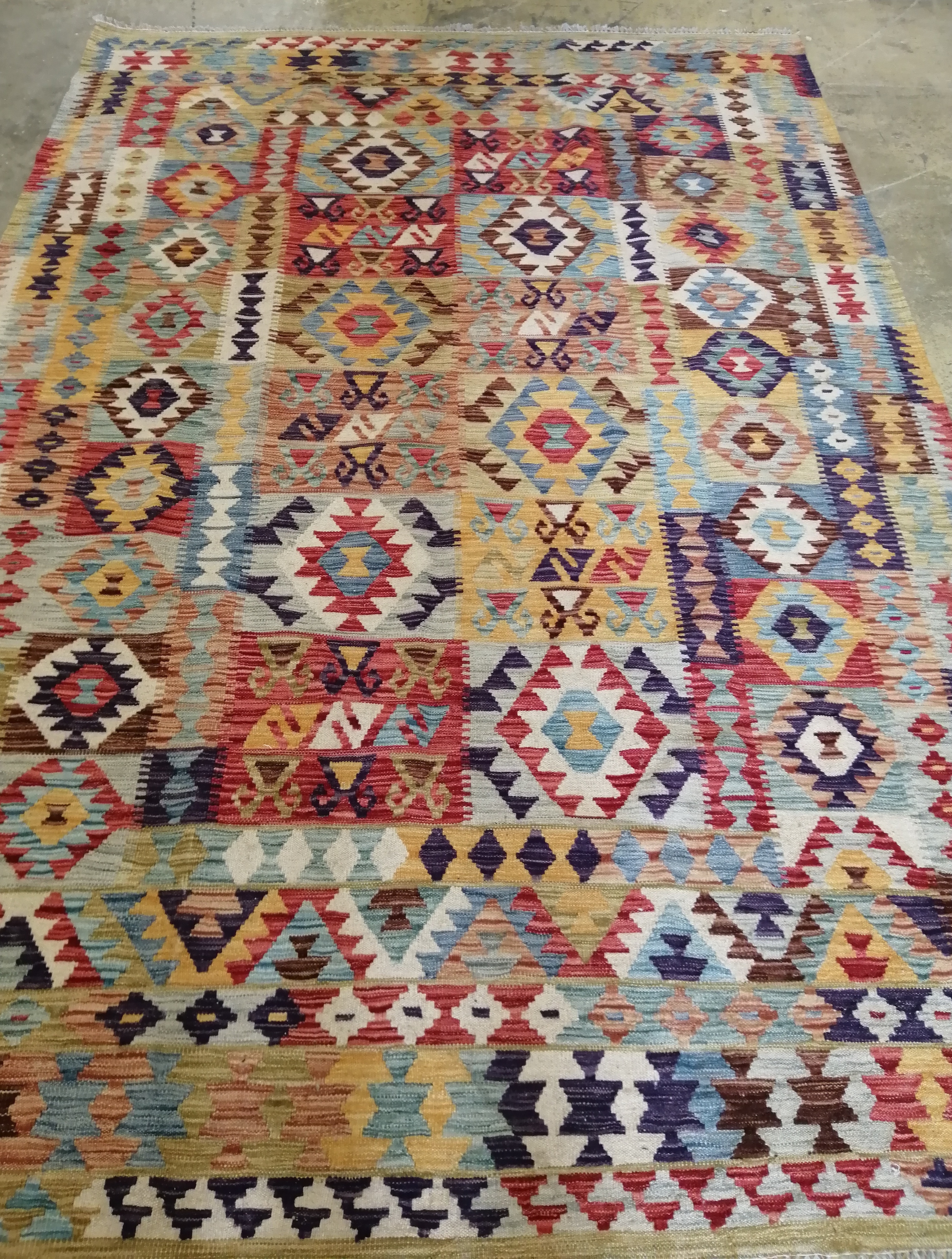 An Anatolian style polychrome Kilim carpet, 295 x 200cm